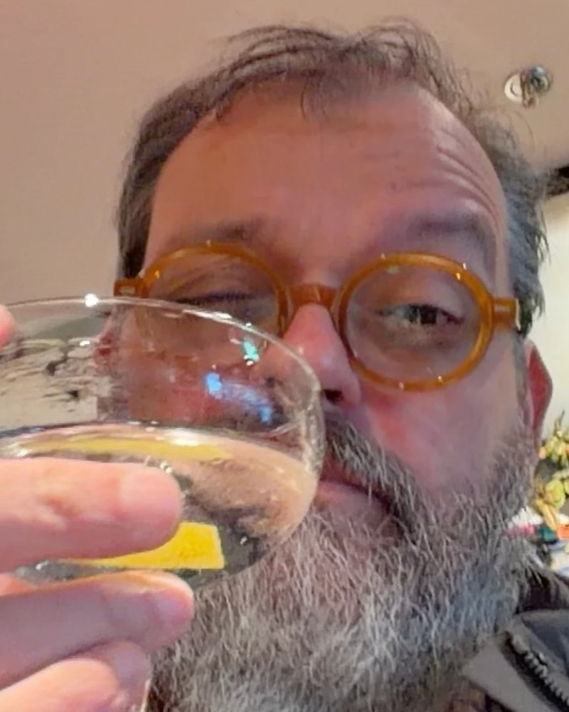 Andy Beach raising a glass with a lemon twist